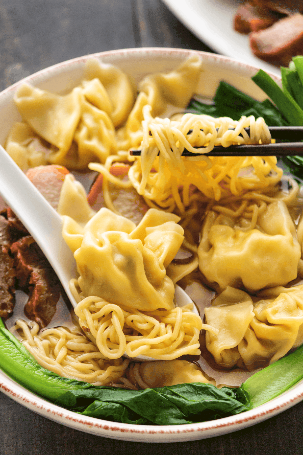 https://www.wokandkin.com/wp-content/uploads/2021/06/Wonton-Egg-Noodle-Soup-Chopsticks-saved-for-web-1200px.png